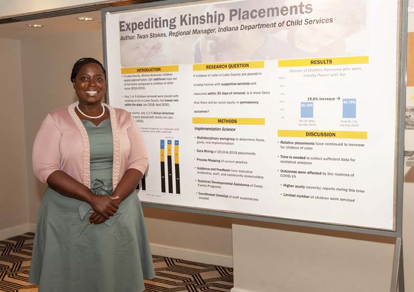 MPLD fellow Twan Stokes standing in front of her poster titled "Expediting Kinship Placements" at the MPLD event in Washington, DC.