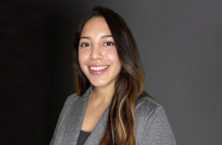 Sarahi Juarez smiling against a dark background