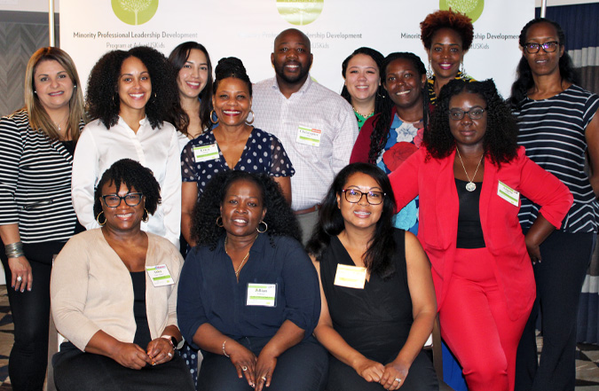Group picture of smiling graduates of most recent Minority Professional Leadership Development Program cohort.