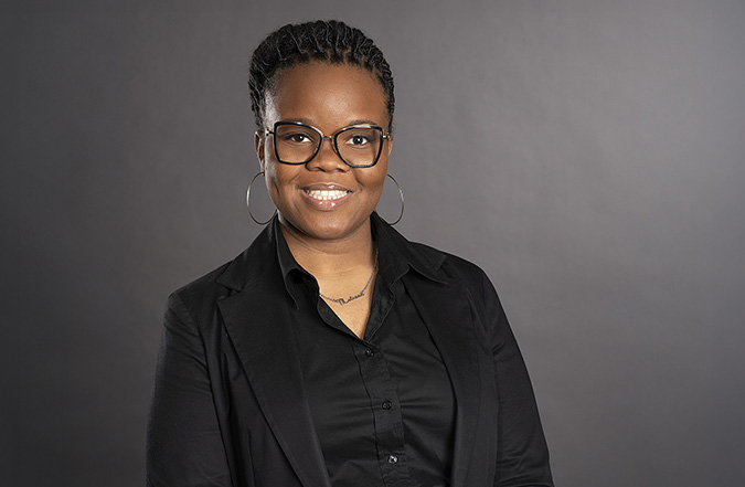 Minority Professional Leadership Development graduate Melissa Fleurio, a woman with short hair and glasses, poses for a professional headshot picture.