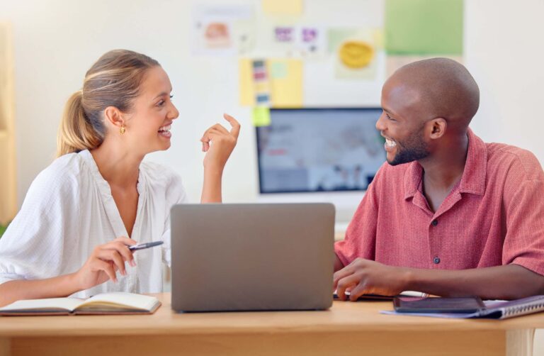 A man and woman discuss post-adoption issues at a desk.